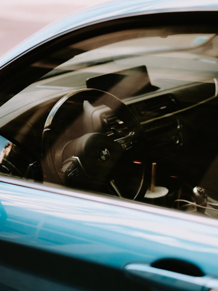 A detailed look into the interior of a luxury car featuring the dashboard and steering wheel.